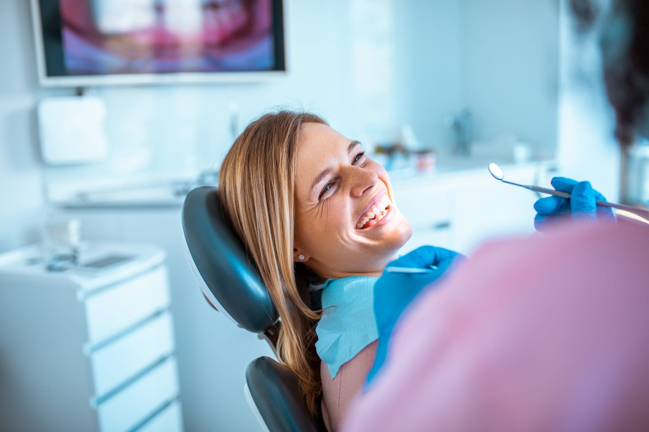 Relieved patient smiling during a dental exam