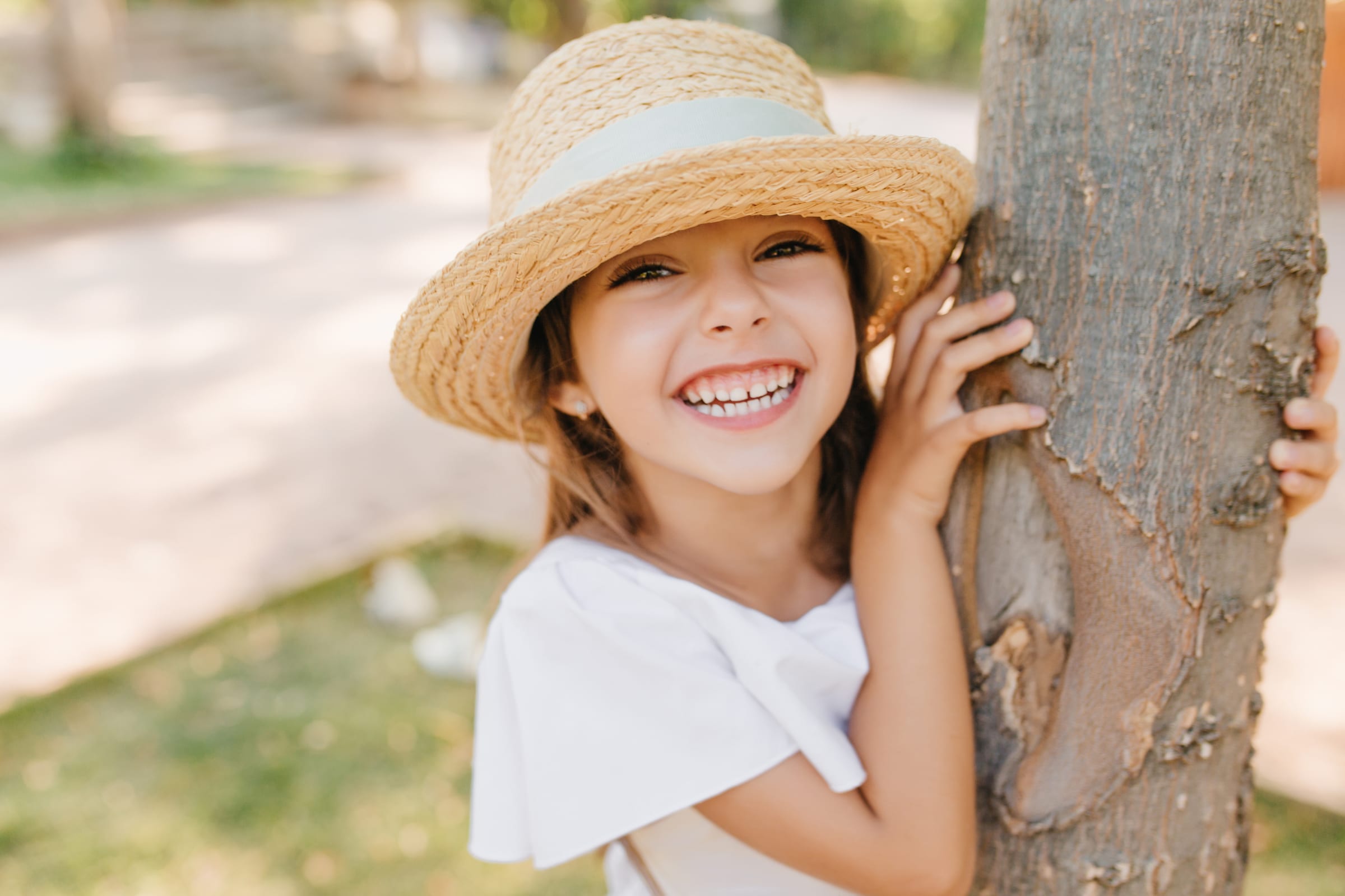 Laughing little girl in a sun hat