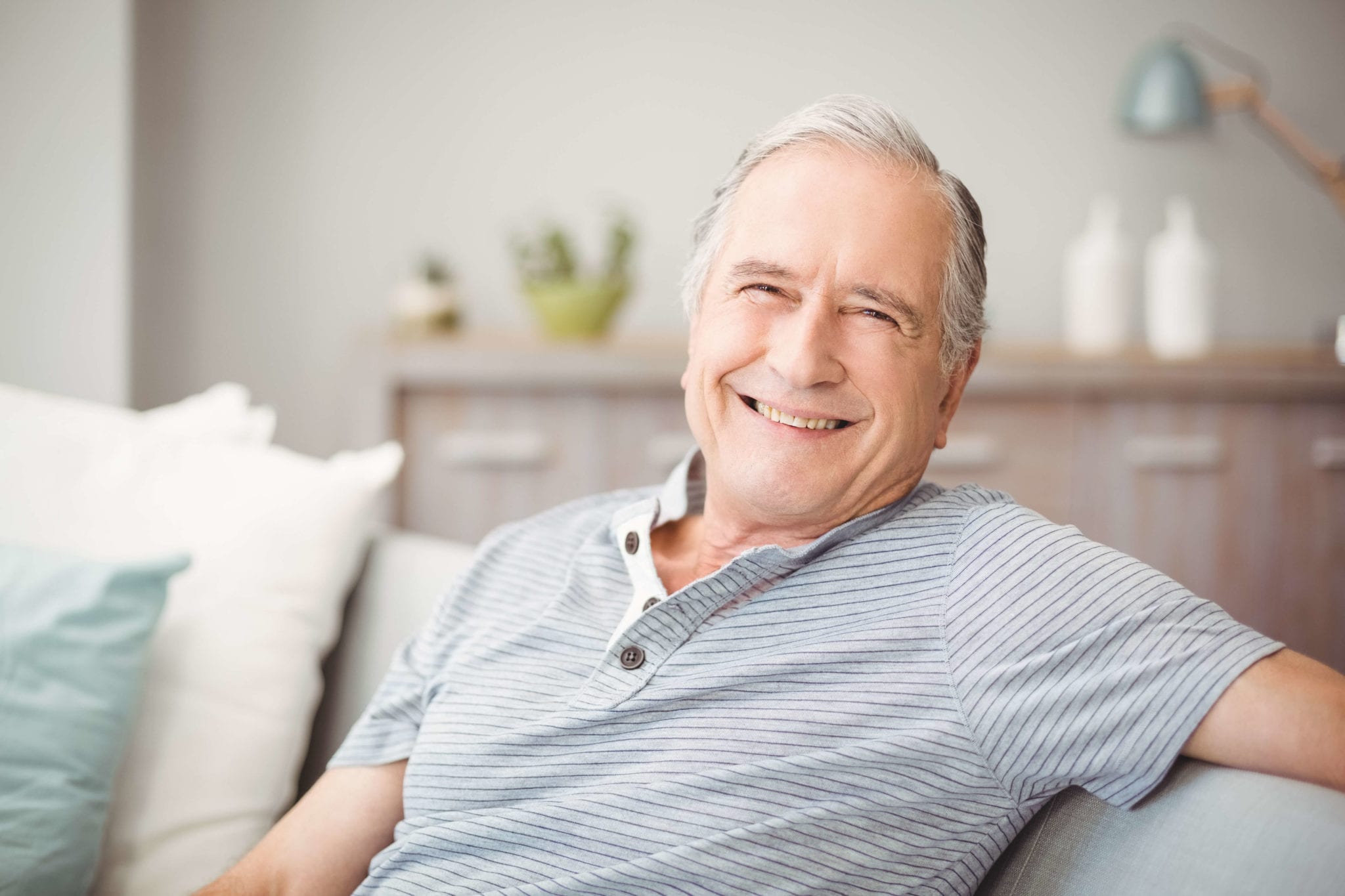 Relaxed, smiling senior man at home