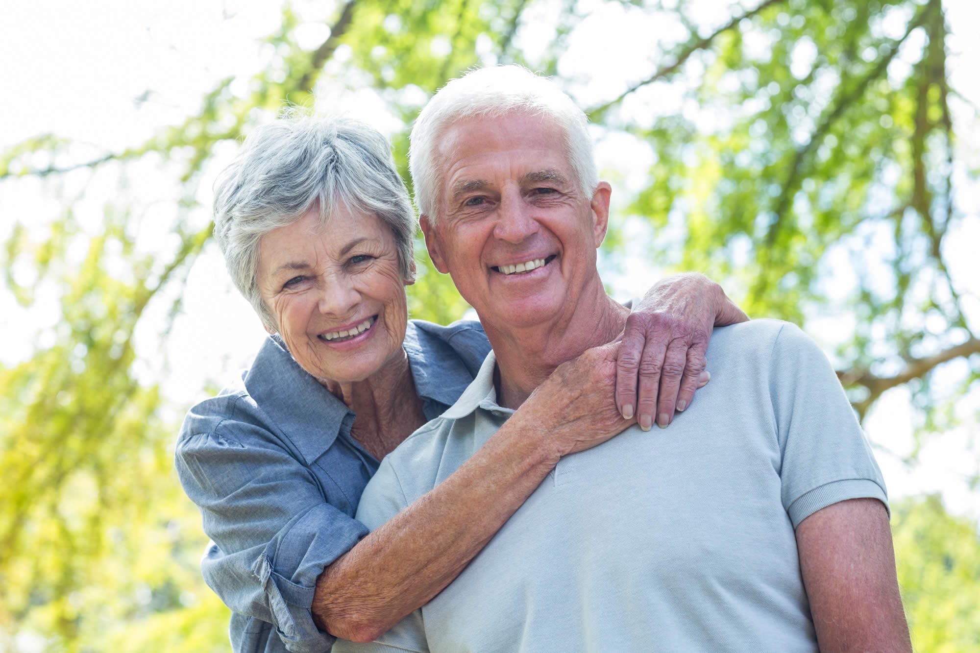 Smiling senior couple embracing outdoors