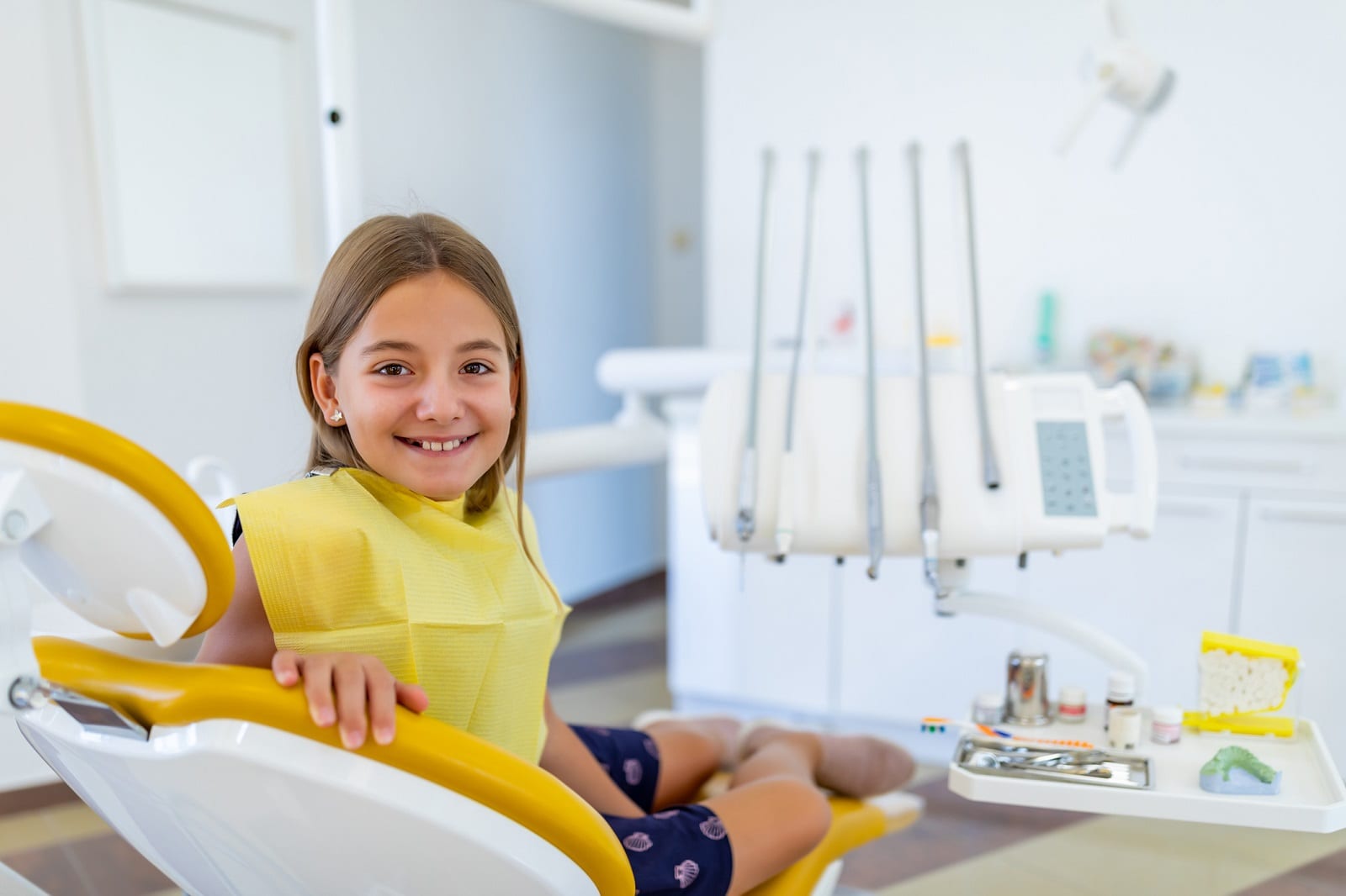 Smiling girl in the dental chair for a cleaning