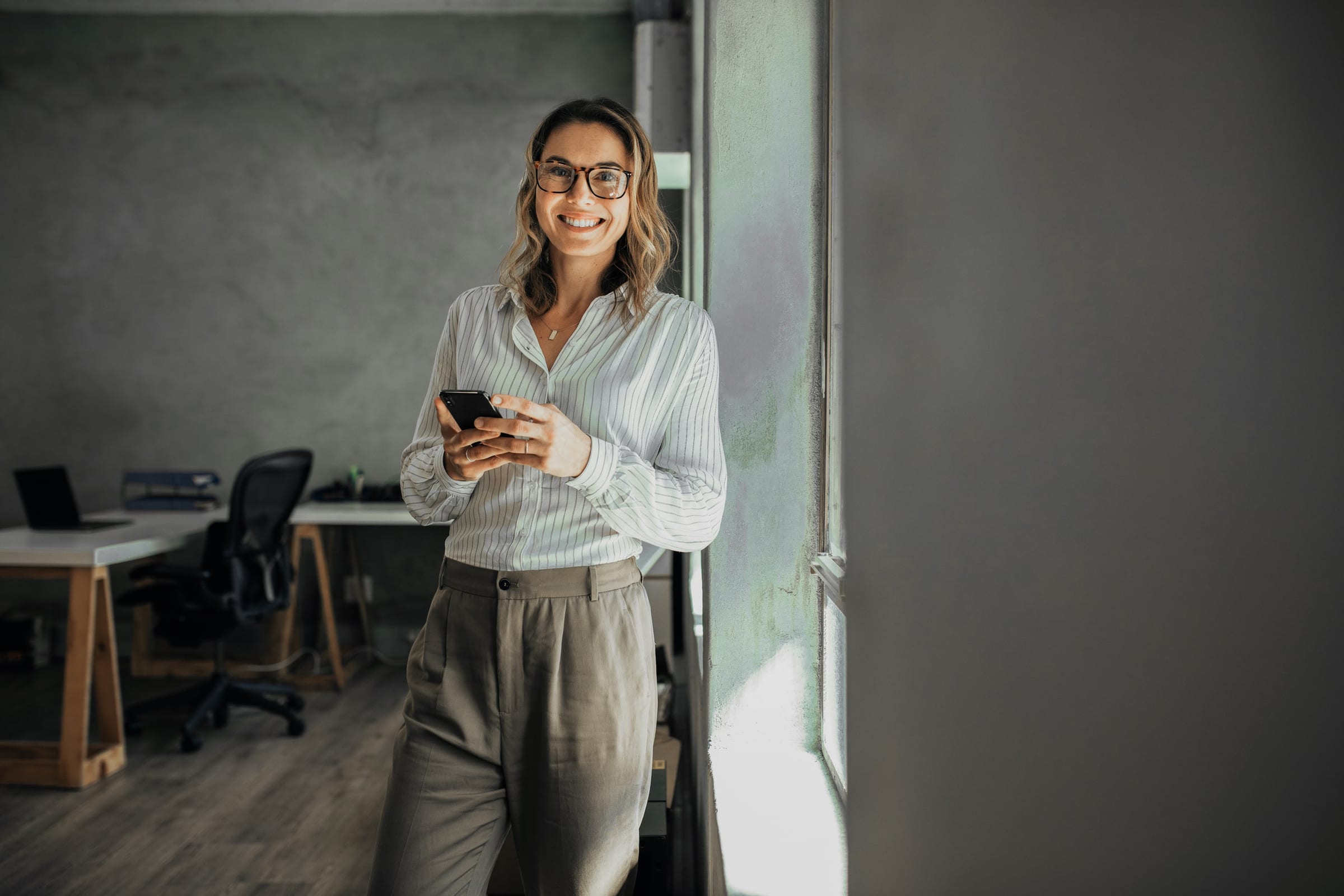 Smiling patient checking her phone before her appointment