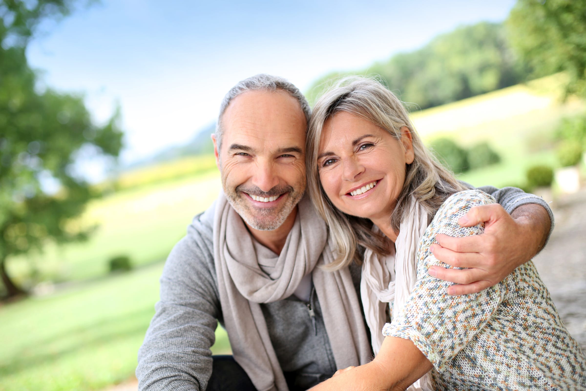 Smiling couple embracing outdoors