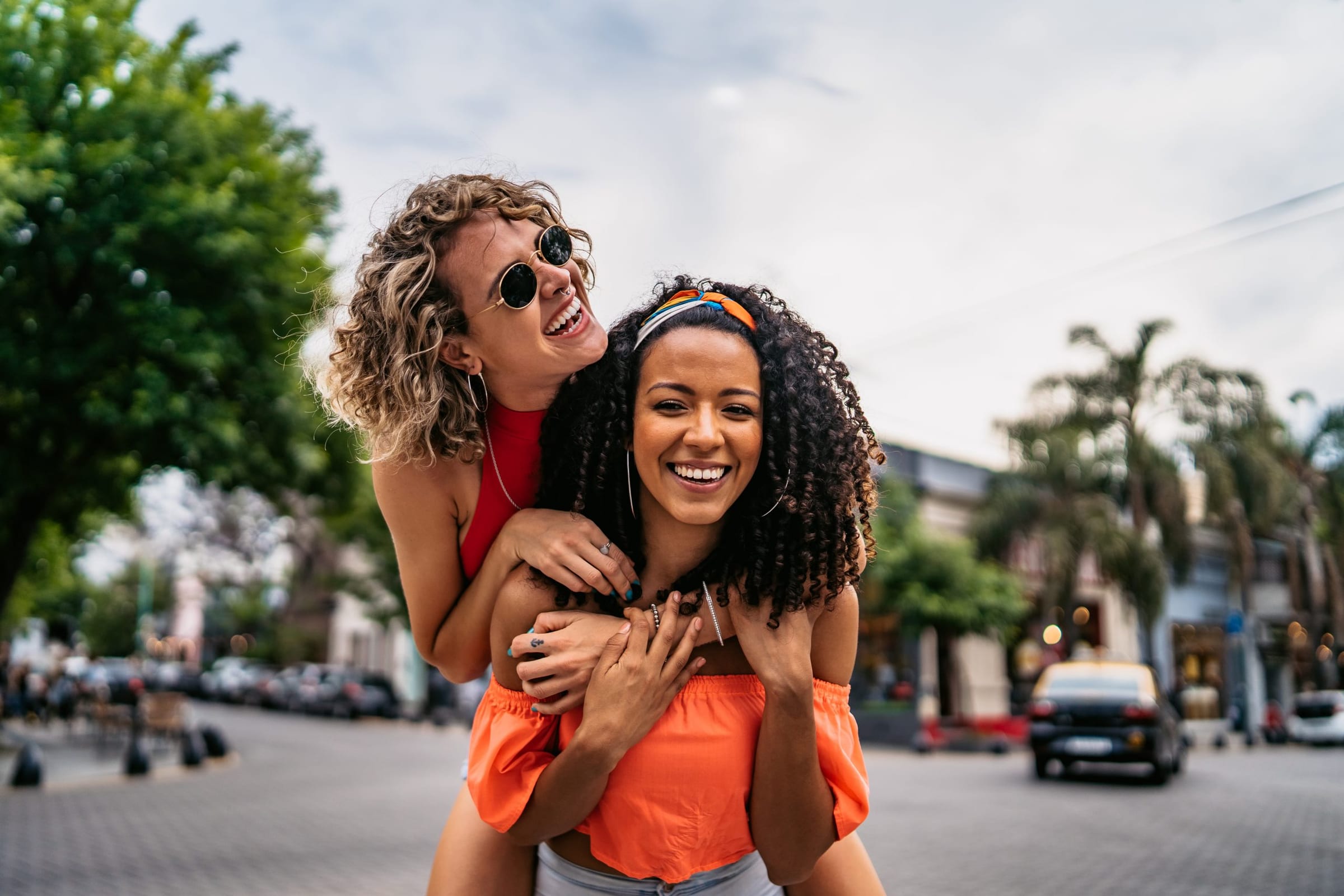 Two friends laughing together outdoors